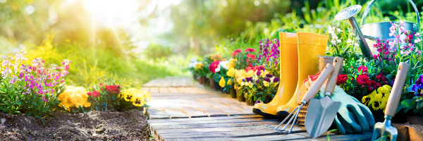 A wooden walkway going through a flowers and gardening supplies.