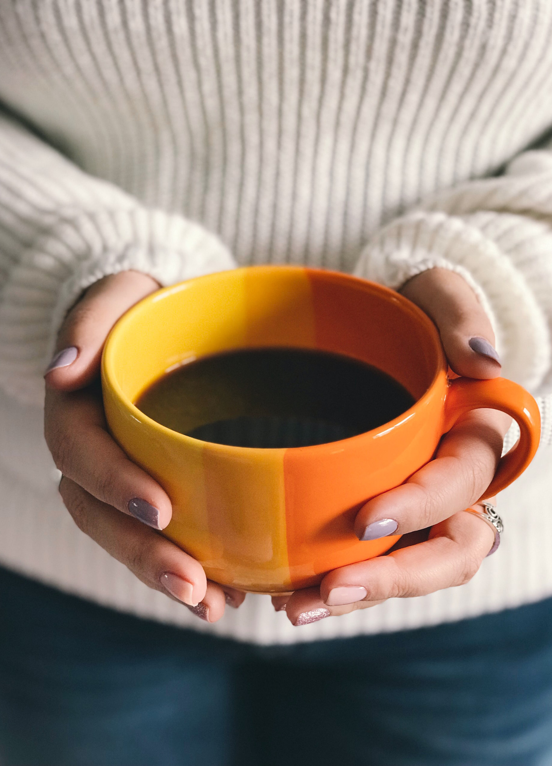 hands holding cup of coffee