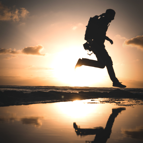 Man Jumping over puddle