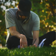 Man with journal outside