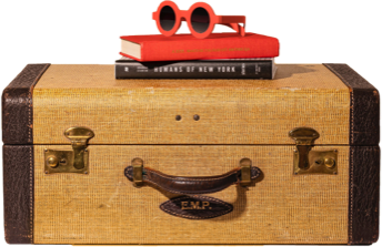 Image of suitcase with two books and sunglasses on top