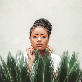 Black woman near green plant