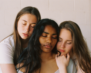 Three girls hugging