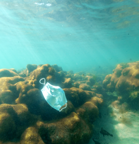 Medical mask at the bottom of the ocean