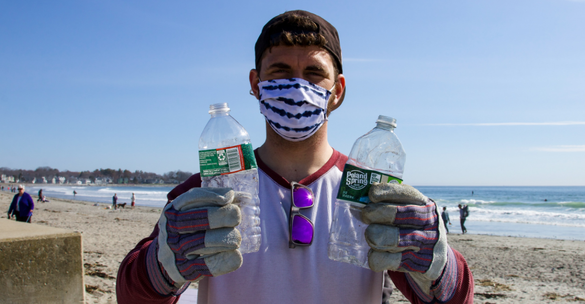 Young man holding plastic bottles